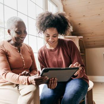 A woman and her older mother video chat with a Home Loan Consultant from Patelco.